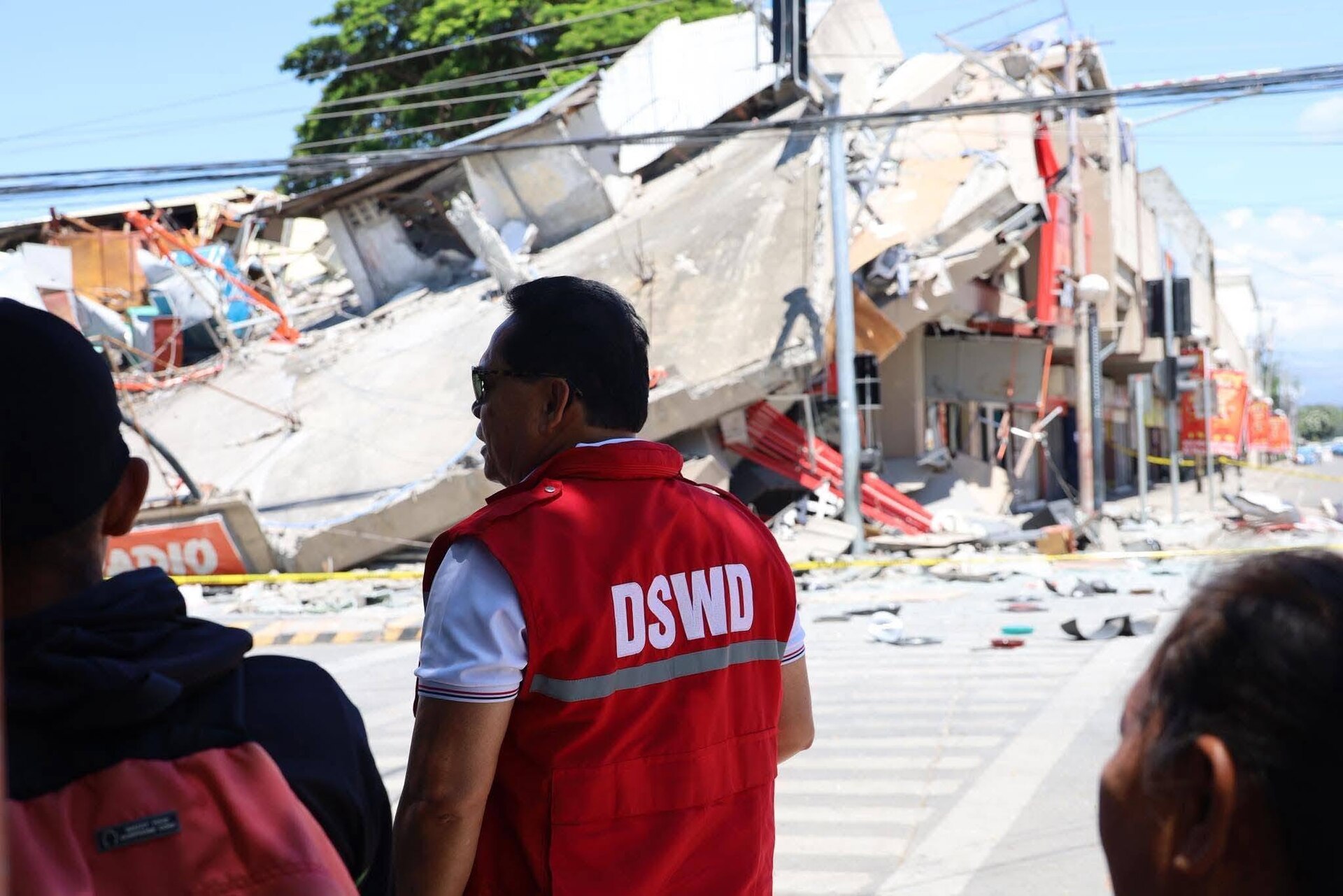 DSWD official observing collapsed building damage in General Santos